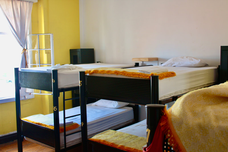 DORM AMARILLO:

This dorm has 3 double bunk beds with showers & separate bathrooms inside the room. Recommended if you want an ensuite inside your dorm & also near a social hotspot. Not recommended if you are not into add-ons. Can fit up to 6 people.